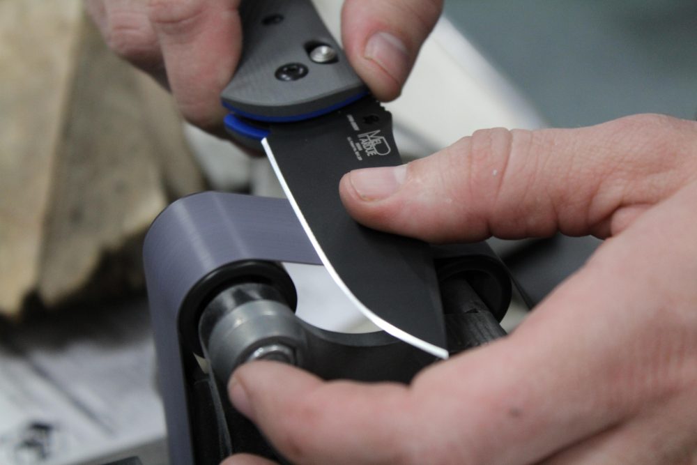 A professional sharpening a knife at H&H Shooting Sports in Oklahoma City