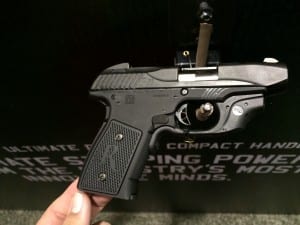 Remington R51 handgun displayed at 2014 SHOT Show with branded backdrop 