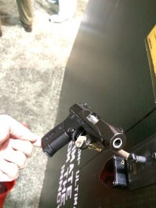 Top view of Remington R51 pistol featured at SHOT Show with promotional signage 