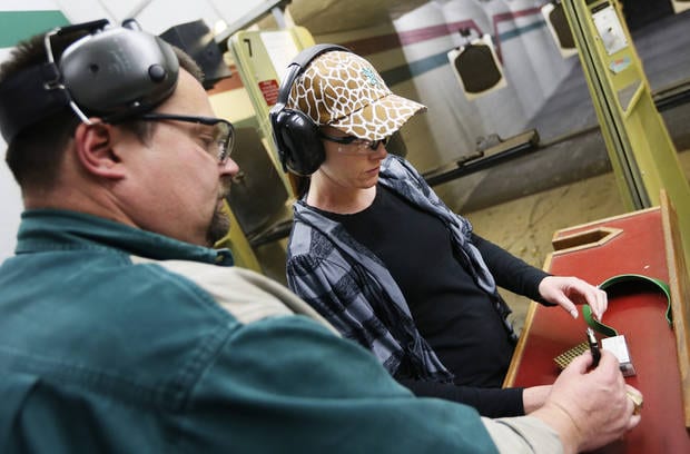 Will Andrews, training coordinator at H&H, shows Tracy Lewis how to load a magazine for her handgun on a gun range during a concealed-carry class at H&H Gun Range and Shooting Sports Complex in Oklahoma City, Wednesday, Jan. 23, 2013. Photo by Nate Billings, The Oklahoman