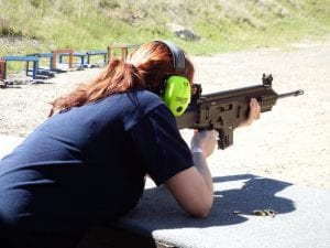 Woman Shooting Gun with Earmuffs H&H Shooting Sports OKC